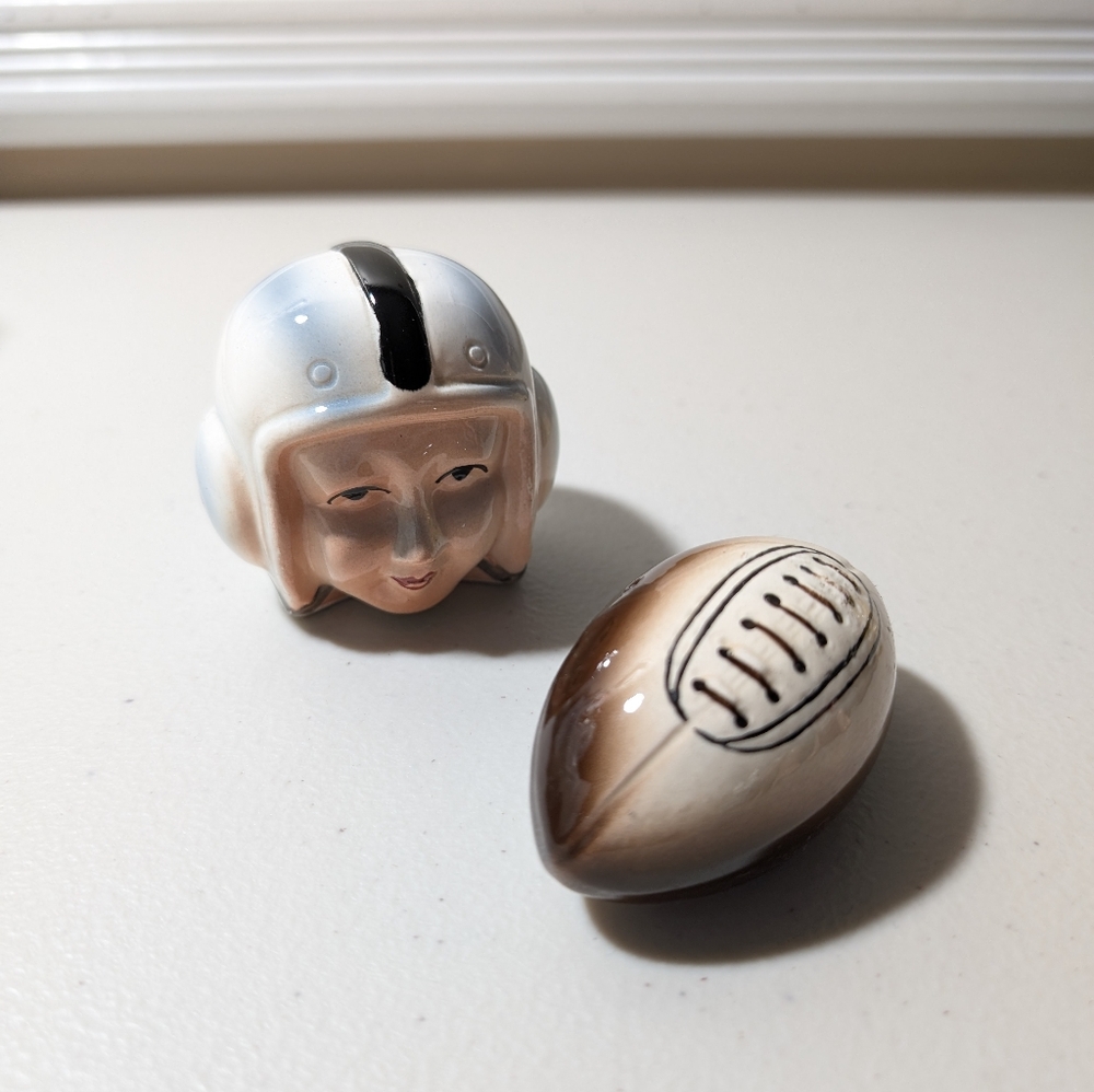 Vintage salt and pepper shakers helmet head and football.